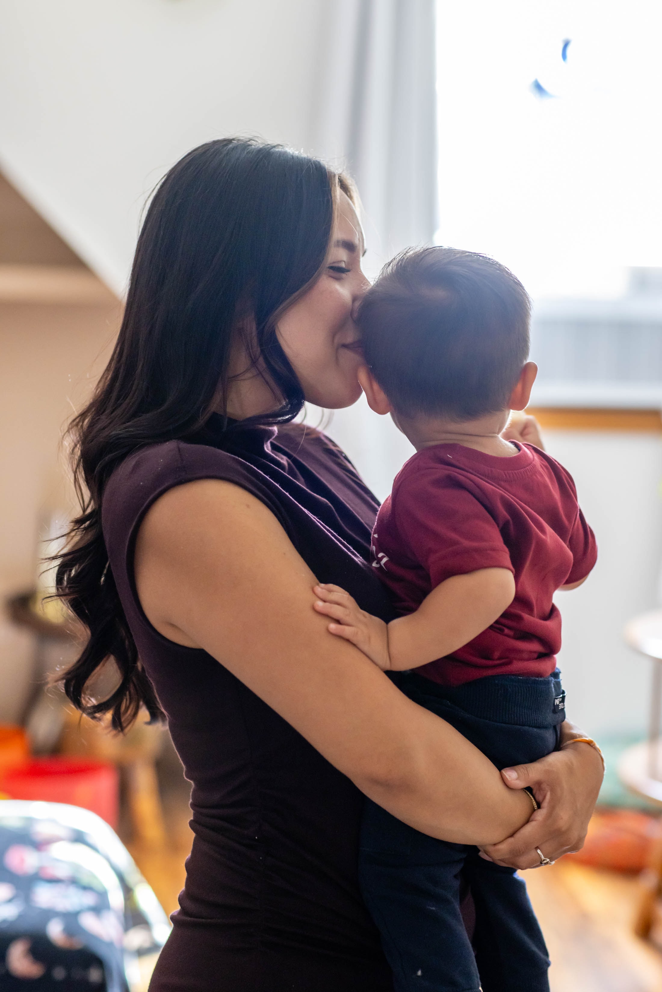 Mother kissing her newborn baby softly