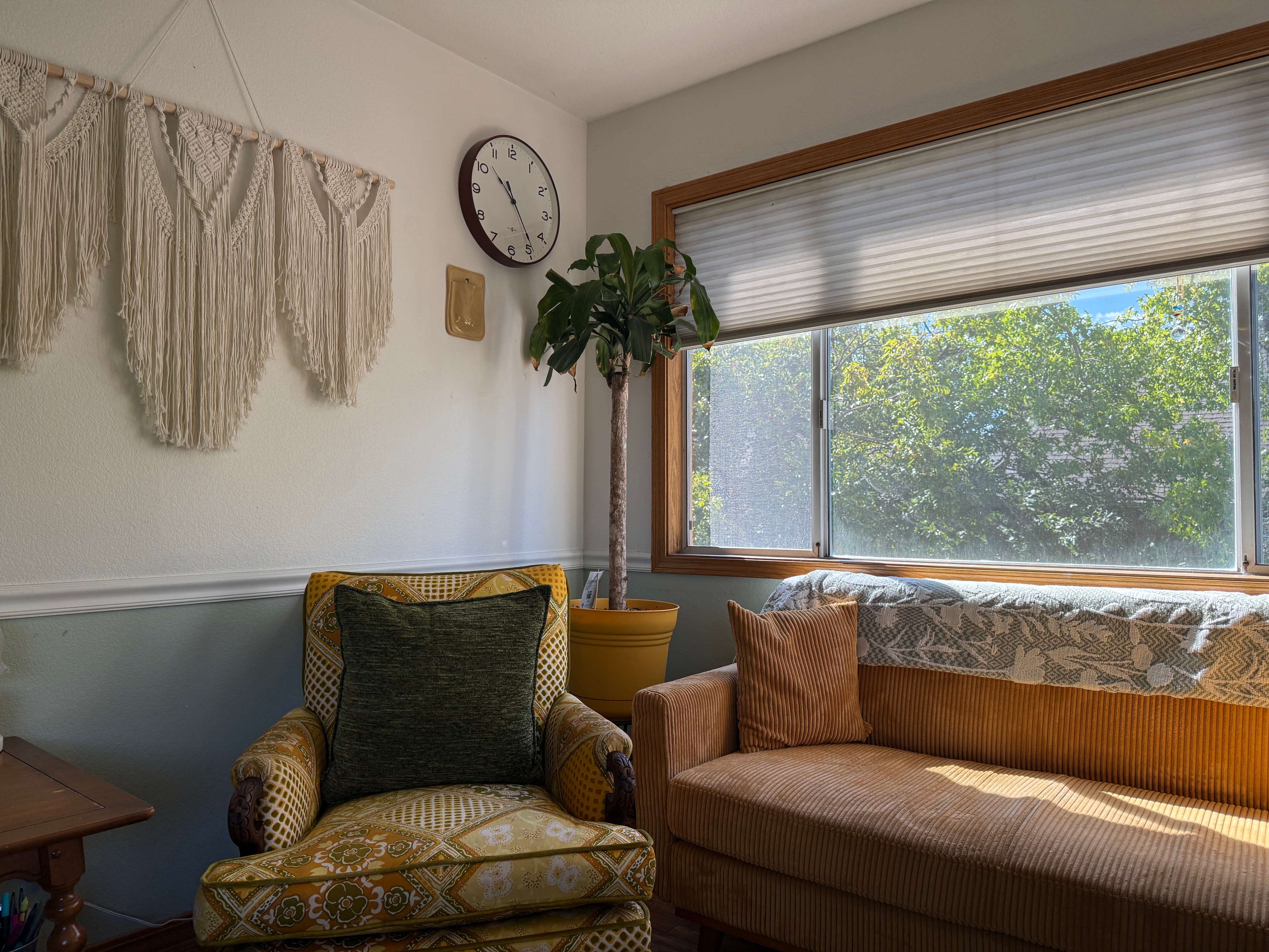 Therapist and client in a warm, light-filled therapy office